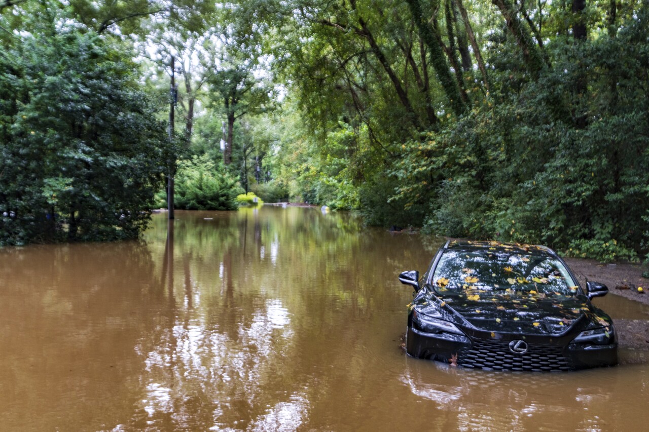 A partially submerged vehicle sits in flood water from after Hurricane Helene passed the area, Friday, Sept 27, 2024, in Atlanta.