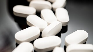 Close-up,Image,Featuring,A,Row,Of,White,,Oval-shaped,Pills,Scattered